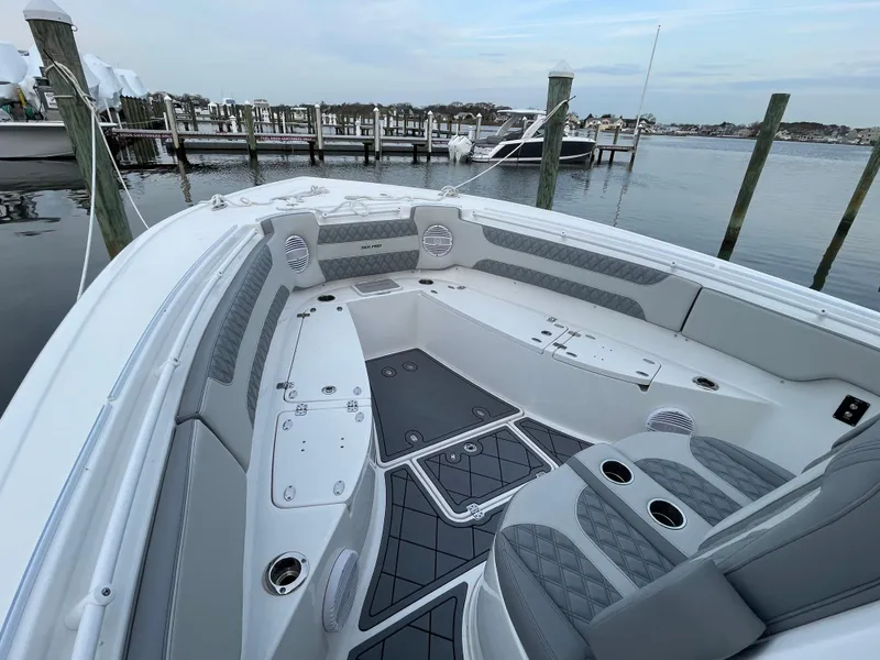 Slide: The Image of 2023 Sea Pro 320 DLX Offshore boat interior at a marina dock. - 11