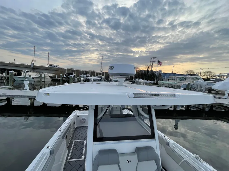 Slide: The Image of 2023 Sea Pro 320 DLX Offshore boat docked at marina during sunset. - 13