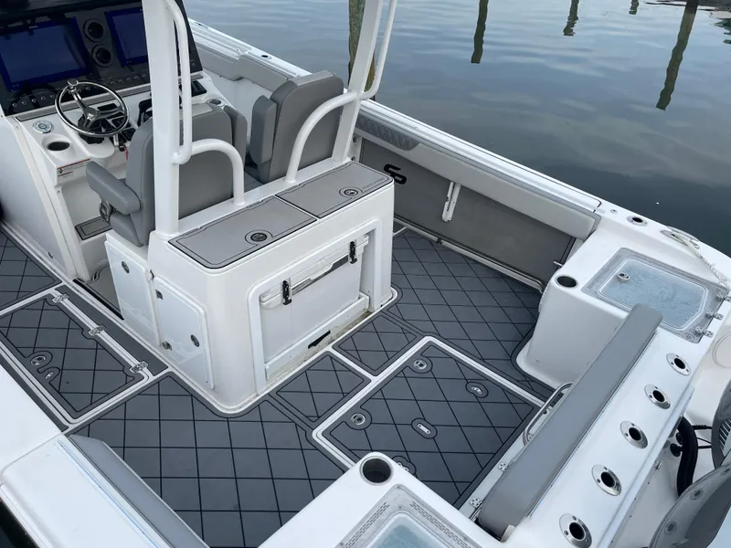 Slide: The Image of 2023 Sea Pro 320 DLX Offshore boat interior with seating and control panel. - 16