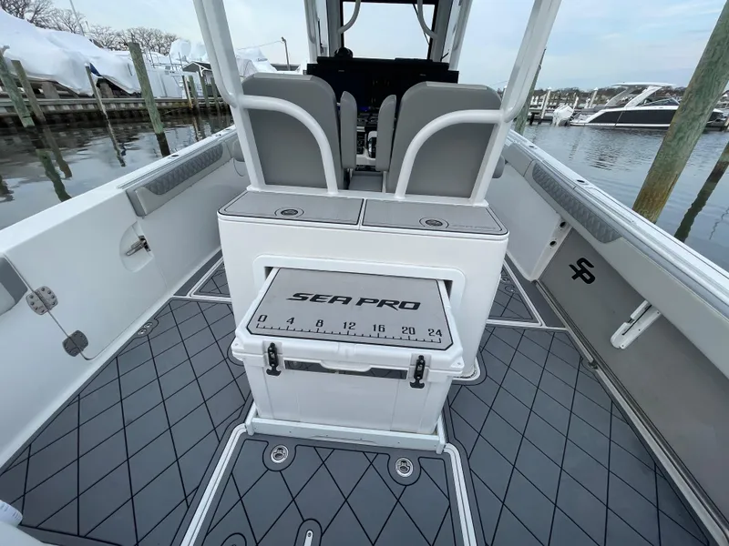 Slide: The Image of 2023 Sea Pro 320 DLX Offshore boat interior with seating and storage. - 17
