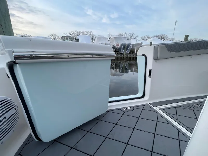 Slide: The Image of 2023 Sea Pro 320 DLX Offshore boat interior with open door, showcasing sleek design. - 19