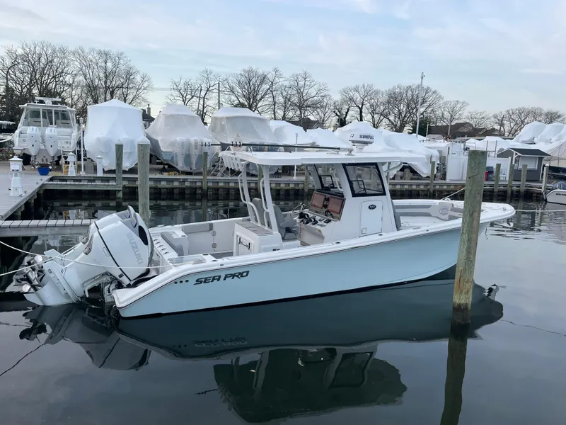 Slide: The Image of 2023 Sea Pro 320 DLX Offshore boat docked in a marina. - 4