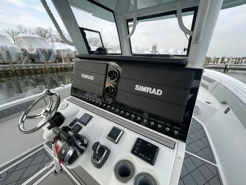Slide: The Image of 2023 Sea Pro 320 DLX Offshore boat dashboard with Simrad electronics. - 7
