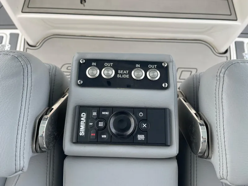 Slide: The Image of 2023 Sea Pro 320 DLX Offshore boat seat controls and Simrad navigation system. - 9