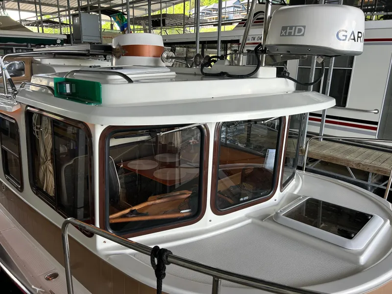 Slide: The Image of 2016 Ranger Tugs R-25SC boat with Garmin radar, docked in a marina. - 13