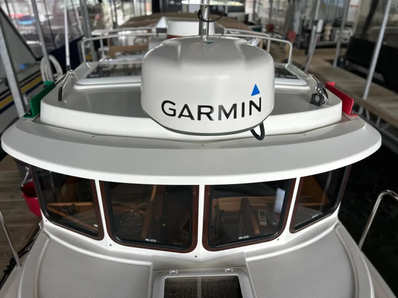 Slide: The Image of 2016 Ranger Tugs R-25SC boat with Garmin radar, docked in a marina. - 14