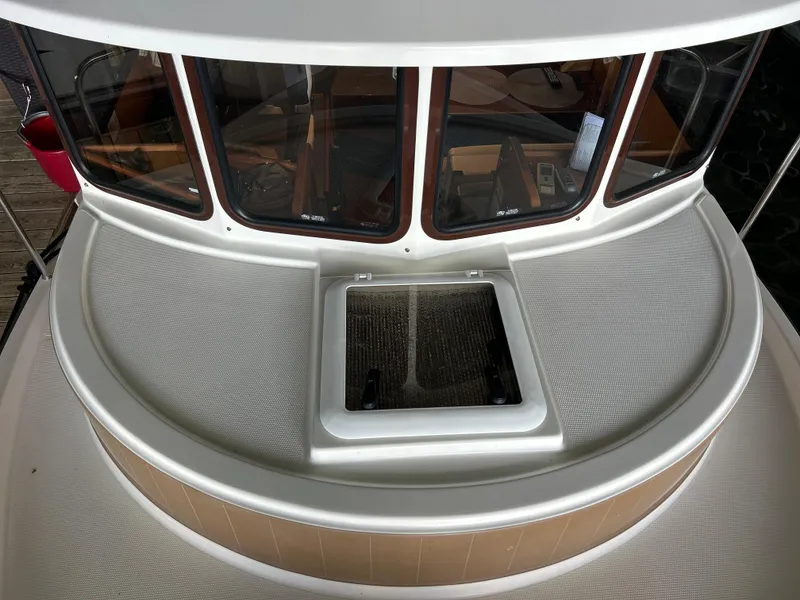 Slide: The Image of 2016 Ranger Tugs R-25SC boat deck with windows and hatch. - 15