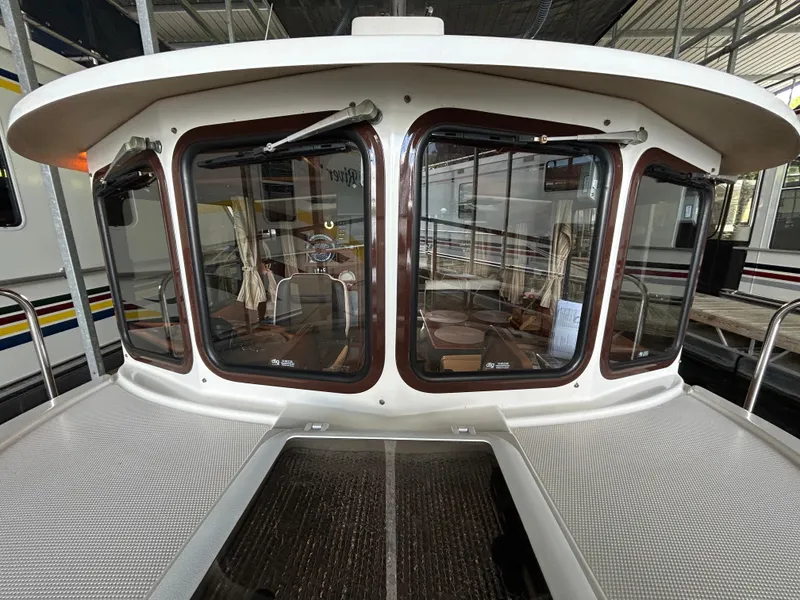 Slide: The Image of 2016 Ranger Tugs R-25SC boat cabin with large windows and interior view. - 16