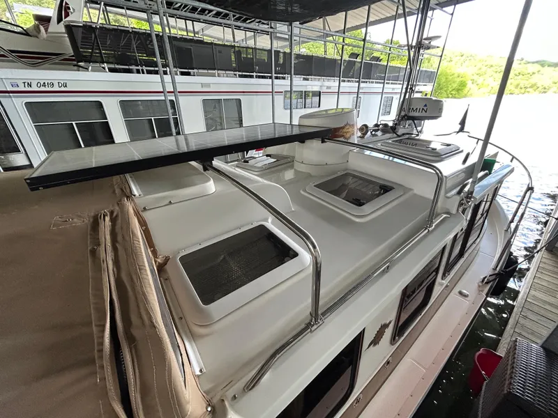 Slide: The Image of 2016 Ranger Tugs R-25SC docked under a covered marina with visible solar panel. - 18