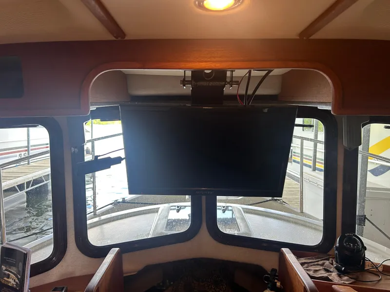 Slide: The Image of Interior view of 2016 Ranger Tugs R-25SC with mounted TV and dockside window. - 24