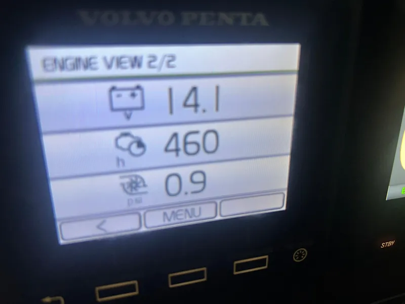 Slide: The Image of Volvo Penta engine display showing battery voltage, engine hours, and pressure on Ranger Tugs R-25SC. - 31