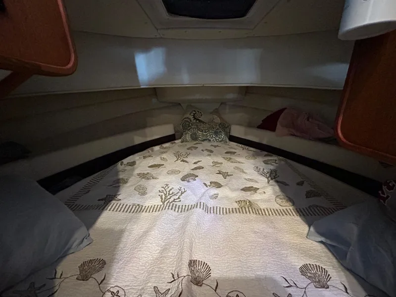 Slide: The Image of Cozy cabin interior of 2016 Ranger Tugs R-25SC with patterned bedding. - 33