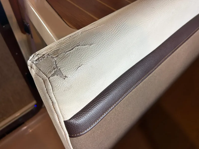 Slide: The Image of Cracked upholstery on 2016 Ranger Tugs R-25SC boat seat, showing wear and tear. - 44