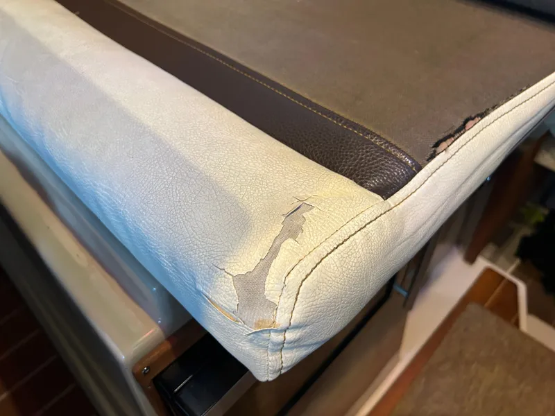 Slide: The Image of Worn upholstery on 2016 Ranger Tugs R-25SC boat seat, showing visible damage. - 46