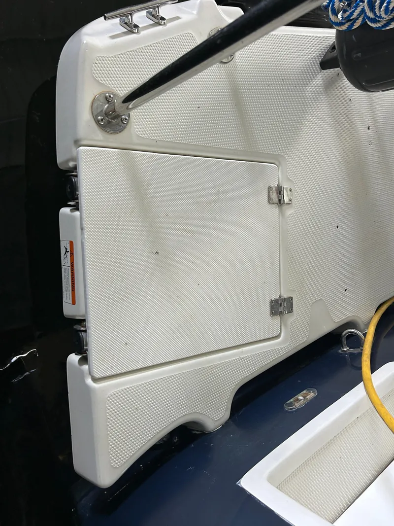 Slide: The Image of 2016 Ranger Tugs R-25SC boat deck with storage compartment and rope detail. - 47