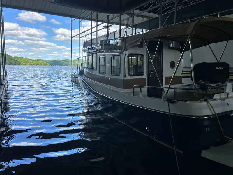Slide: The Image of 2016 Ranger Tugs R-25SC docked under a canopy on a sunny day. - 6