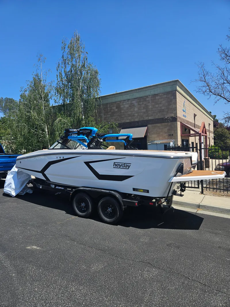 Slide: The Image of 2025 HEYDAY WAKE BOATS WT-2DC on trailer, parked outdoors near a building. - 11