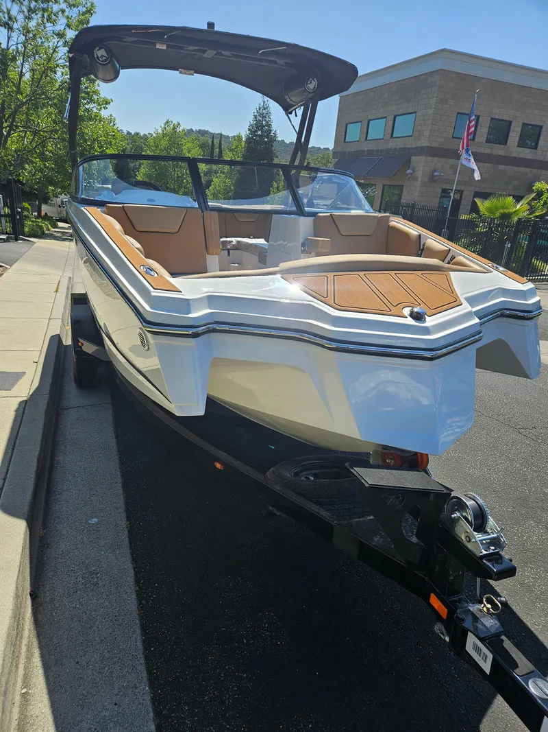 Slide: The Image of 2025 HEYDAY WAKE BOATS WT-2DC on trailer, parked on street, sunny day. - 4