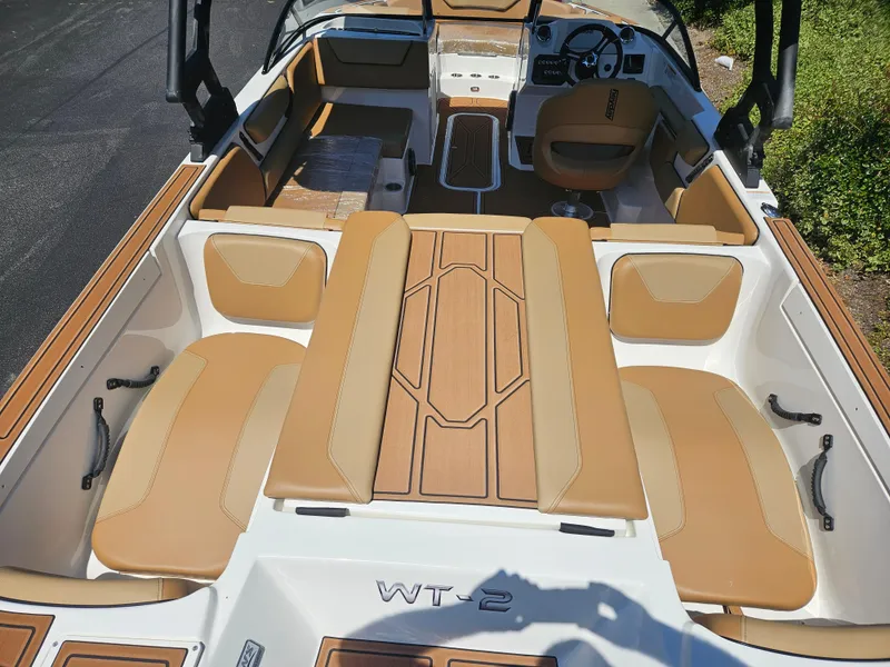 Slide: The Image of 2025 HEYDAY WAKE BOATS WT-2DC interior with tan seating and modern dashboard. - 6