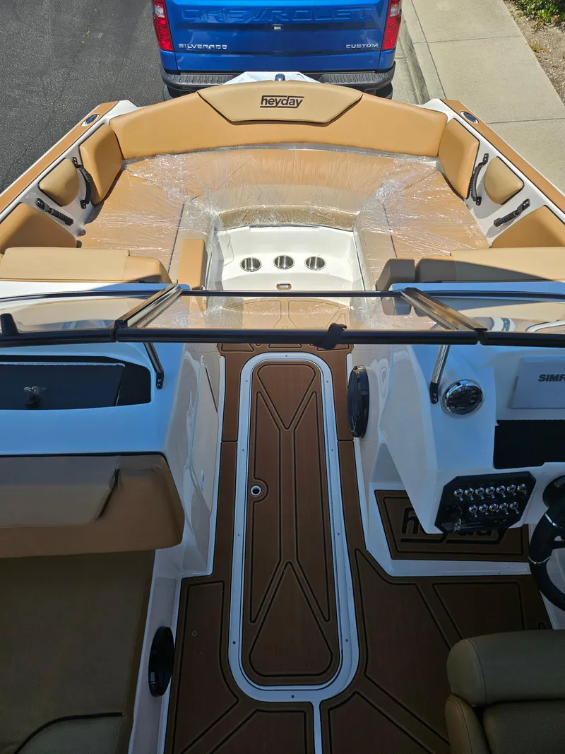 Slide: The Image of 2025 HEYDAY WAKE BOATS WT-2DC interior with tan seating and modern dashboard. - 8