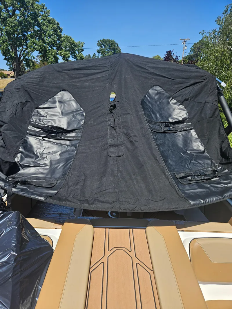 Slide: The Image of 2025 HEYDAY WAKE BOATS WT-2DC with black cover, outdoor setting. - 9