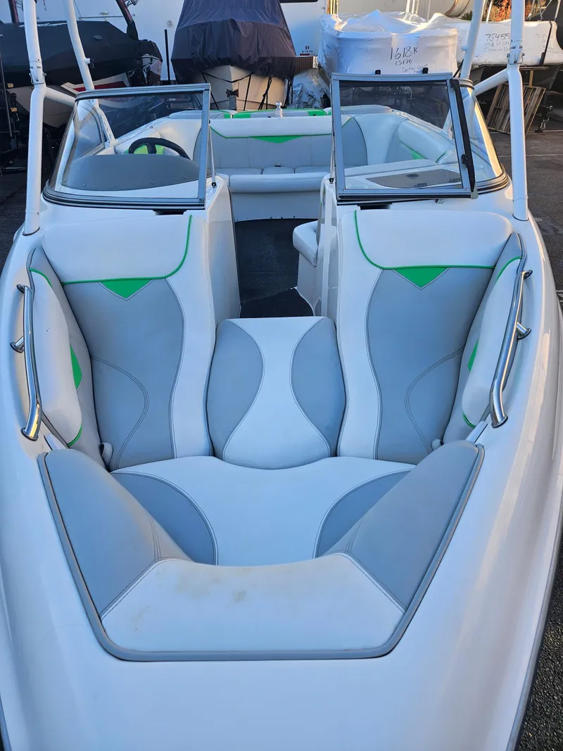 Slide: The Image of 2005 Tigé 22V boat interior with gray and green seating, open bow design. - 3