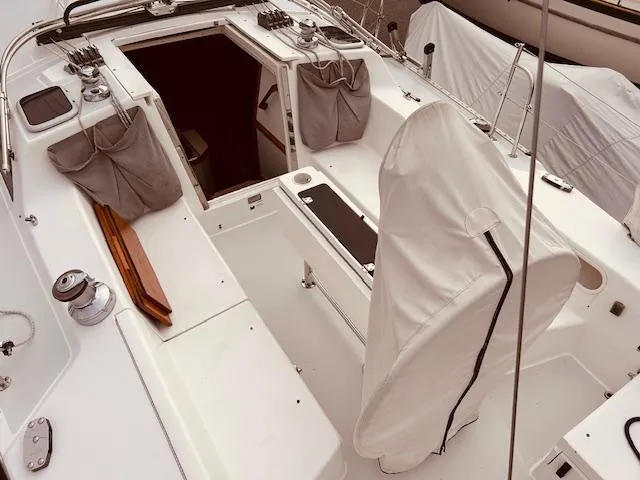 Slide: The Image of Cockpit of a 2003 Catalina 36 MkII sailboat with covered seating and storage. - 14