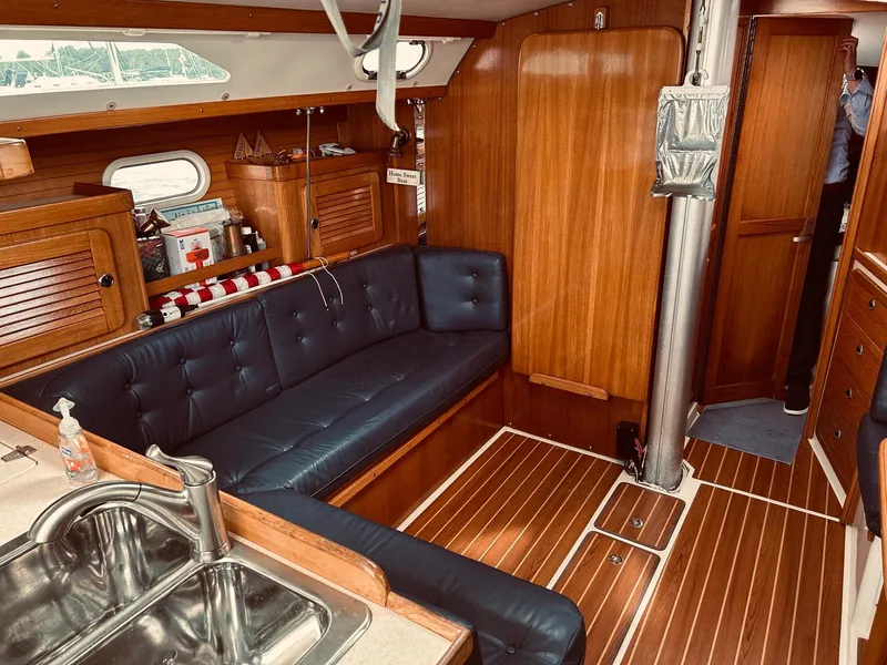 Slide: The Image of Interior of 2003 Catalina 36 MkII sailboat with wooden finish and blue seating. - 18