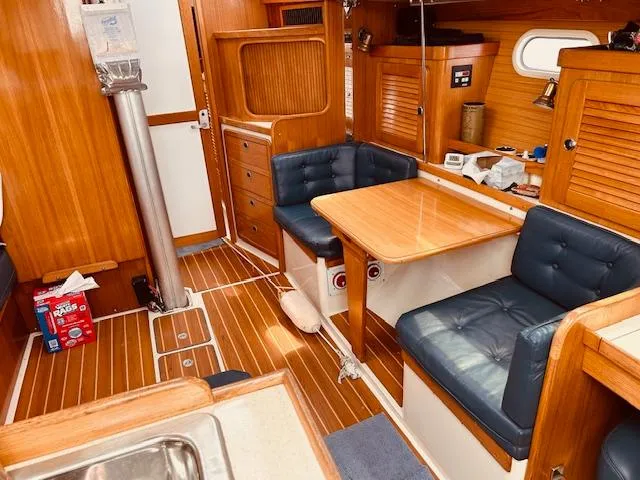 Slide: The Image of Interior of 2003 Catalina 36 MkII sailboat with wooden furnishings and blue seating. - 20