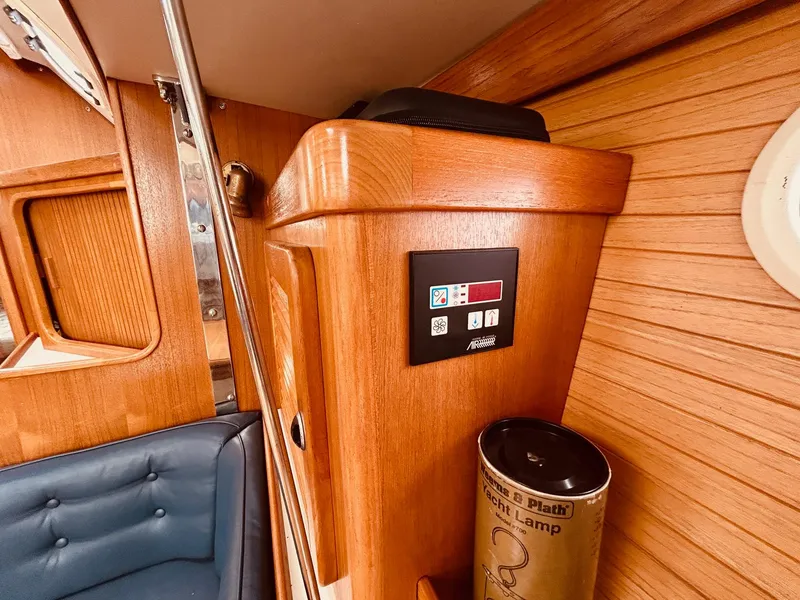 Slide: The Image of Interior of 2003 Catalina 36 MkII yacht with wooden paneling and control panel. - 29