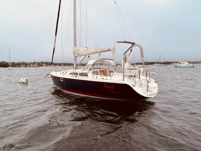 Slide: The Image of 2003 Catalina 36 MkII sailboat anchored on calm water. - 3