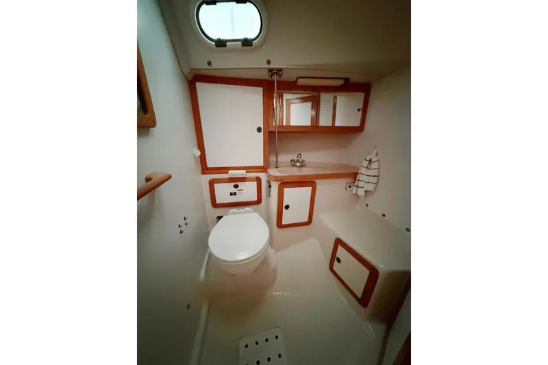 Slide: The Image of Bathroom interior of 2003 Catalina 36 MkII sailboat, featuring compact design and wooden accents. - 31