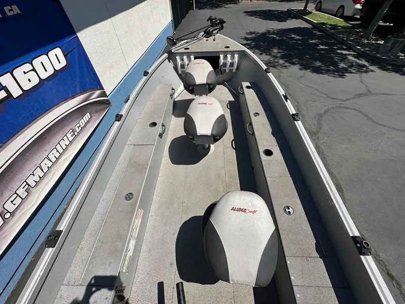 Slide: The Image of 2018 Alumacraft Yukon 165 boat interior with seating and storage compartments. - 10