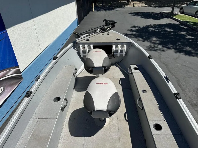 Slide: The Image of 2018 Alumacraft Yukon 165 boat interior with seating and storage compartments. - 11