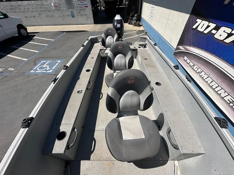 Slide: The Image of 2018 Alumacraft Yukon 165 boat interior with seating and storage compartments. - 15