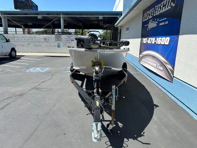 Slide: The Image of 2018 Alumacraft Yukon 165 boat on trailer in parking lot, front view. - 2
