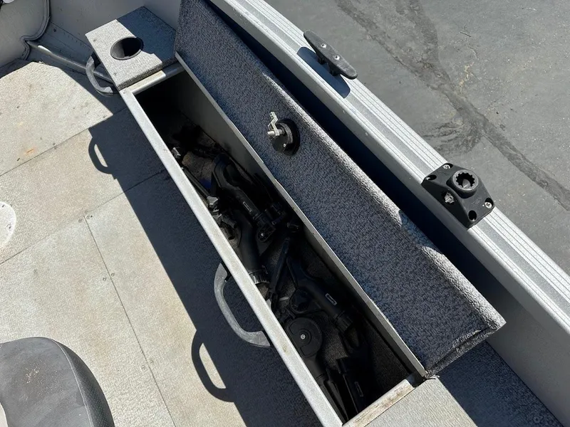 Slide: The Image of 2018 Alumacraft Yukon 165 boat storage compartment with fishing gear inside. - 20
