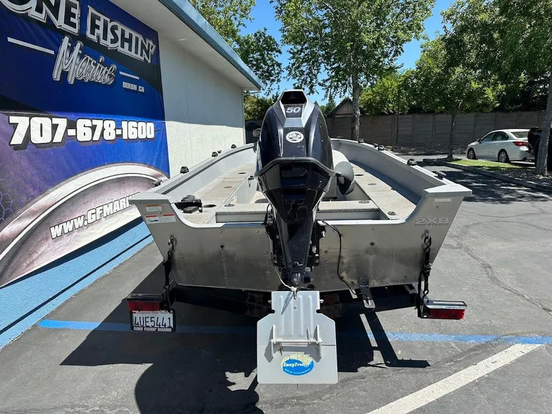 Slide: The Image of 2018 Alumacraft Yukon 165 boat with outboard motor in parking lot. - 8