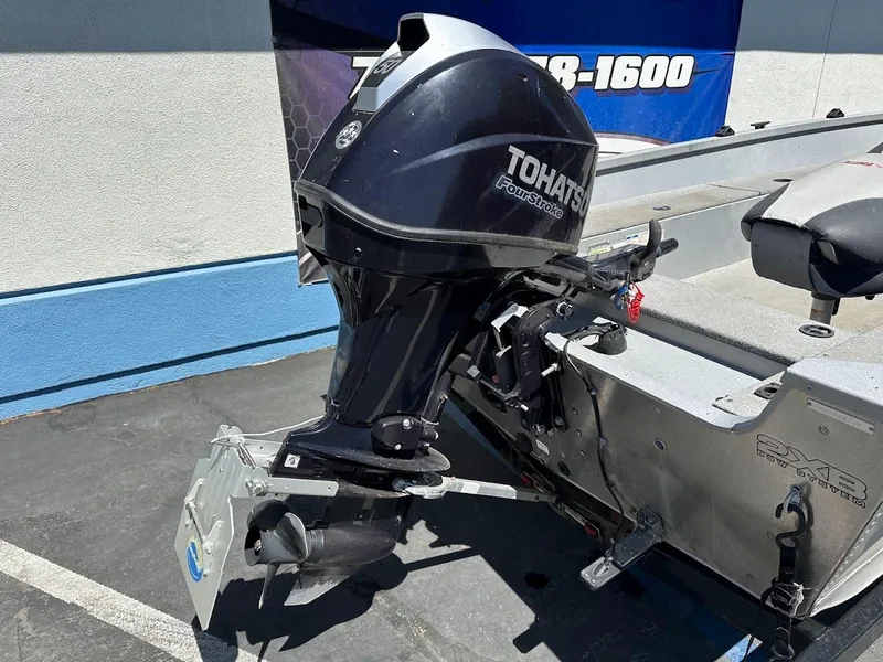 Slide: The Image of 2018 Alumacraft Yukon 165 boat with Tohatsu outboard motor in a parking lot. - 9