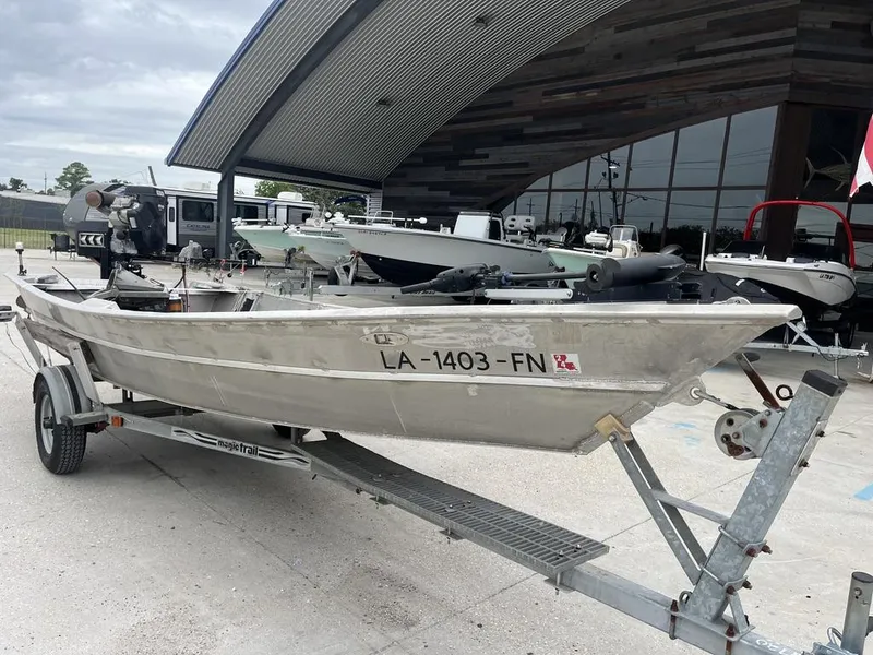 Slide: The Image of Aluminum boat on trailer outside a modern building, Custom model 17, year 2006. - 1