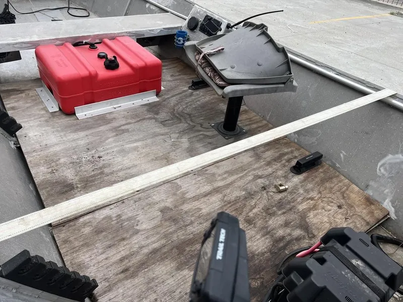 Slide: The Image of Interior of a custom 2006 boat with red fuel tank and wooden flooring. - 10