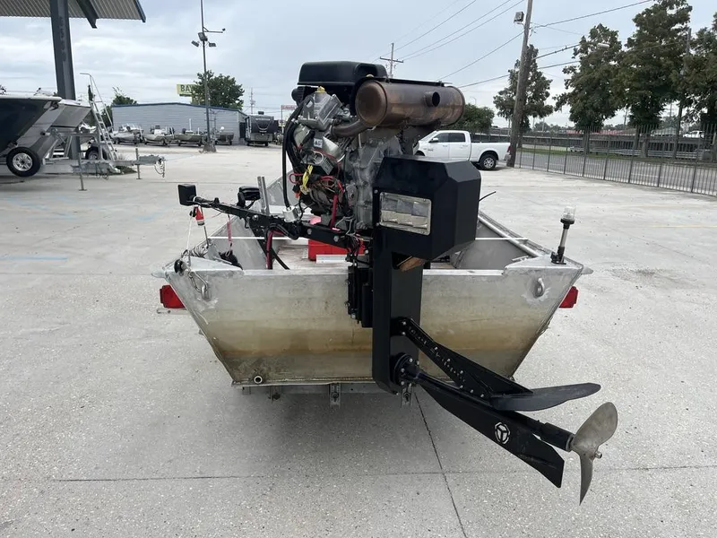 Slide: The Image of Aluminum boat with custom engine and propeller, parked outdoors, 2006 model. - 4