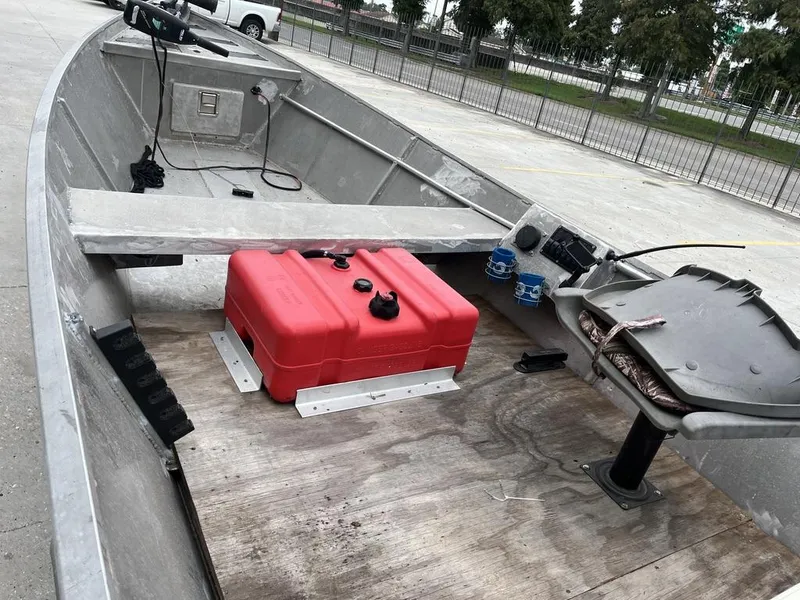 Slide: The Image of Aluminum boat interior with red fuel tank and fishing equipment, Custom model 17, 2006. - 6