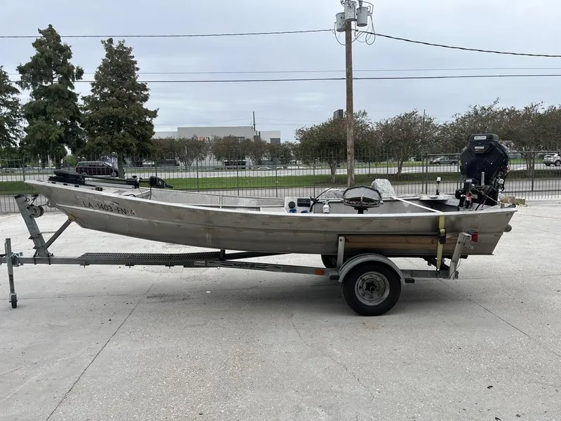 Slide: The Image of Aluminum fishing boat on trailer, Custom 17 model, 2006, parked outdoors. - 7