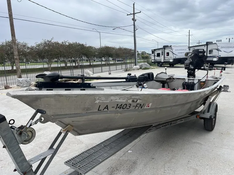 Slide: The Image of Aluminum fishing boat on trailer, Custom model 17, year 2006, parked outdoors. - 8