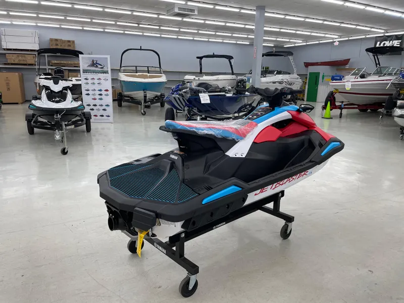 Slide: The Image of 2025 Yamaha WaveRunner JetBlaster DLX 3-Up displayed in a showroom with other watercraft. - 5