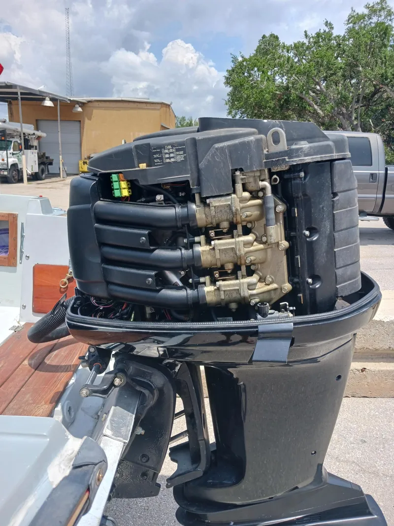 Slide: The Image of 1980 Hydra-Sports 2106 Vector outboard motor in a parking lot setting. - 19