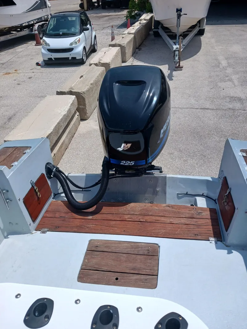 Slide: The Image of 1980 Hydra-Sports 2106 Vector boat with a 225 HP outboard motor, docked outdoors. - 8