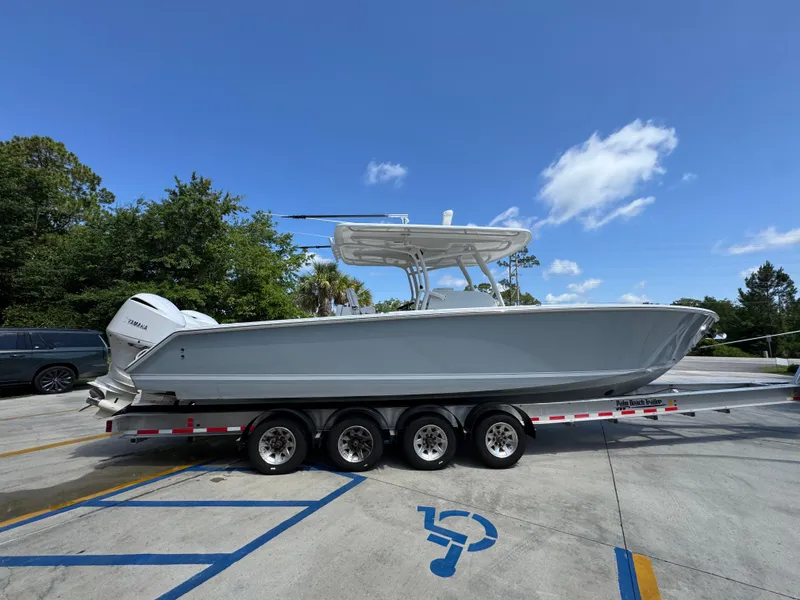 Slide: The Image of 2018 Jupiter 34 HFS boat on trailer under clear blue sky. - 10