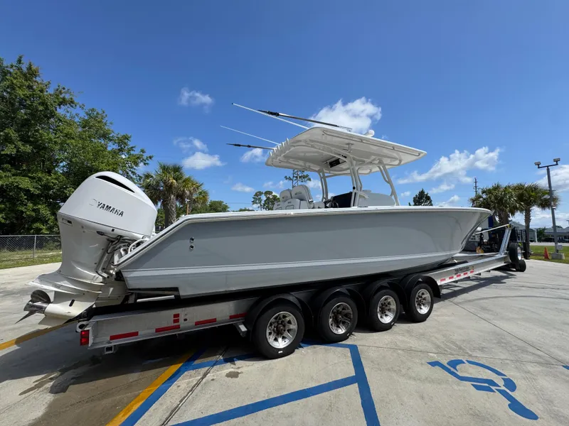 Slide: The Image of 2018 Jupiter 34 HFS boat on trailer with Yamaha engine, parked outdoors. - 11